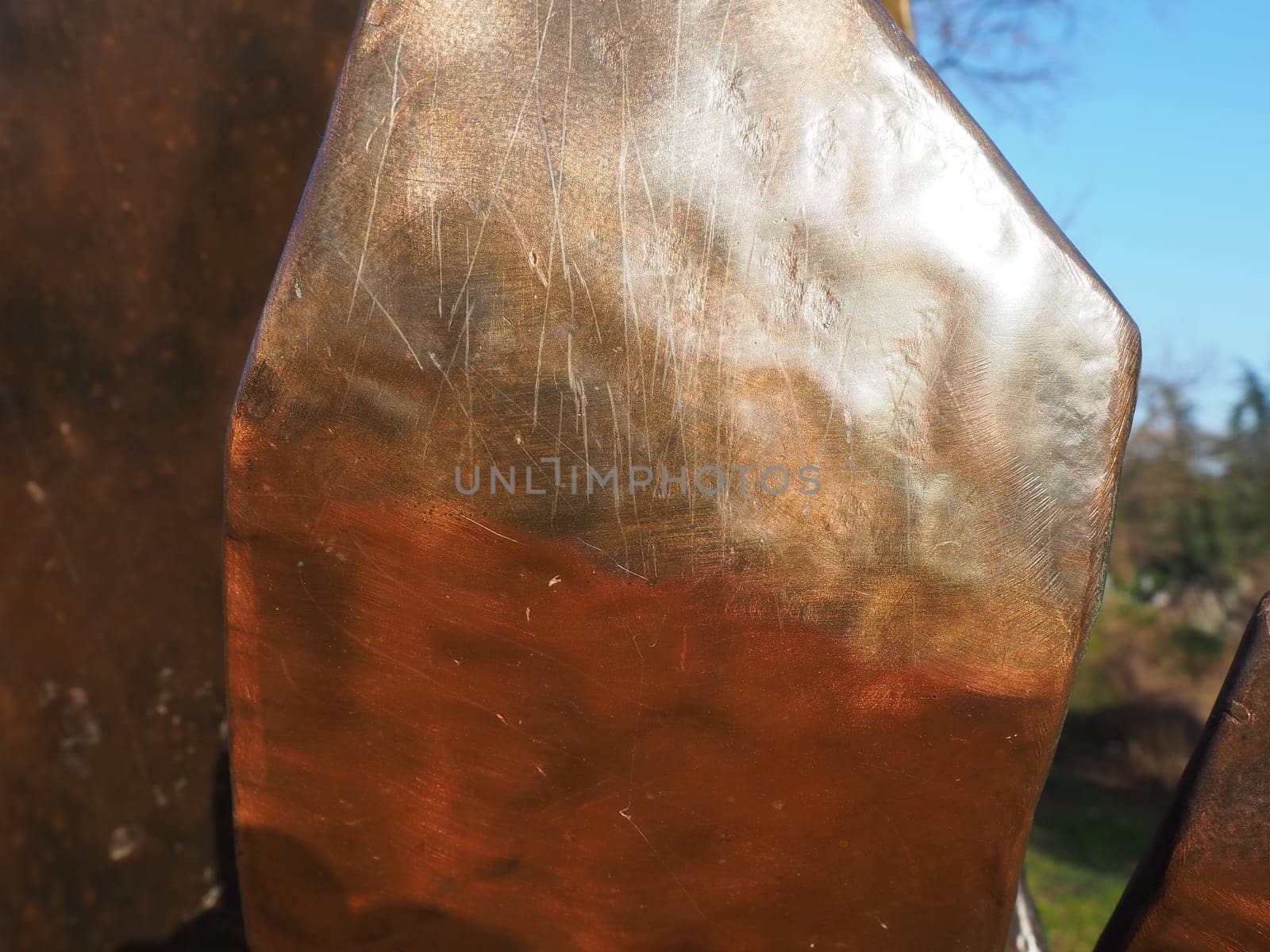 Metal bronze textured plate. Bronze or copper polished surface with dents, scratches and indentations. Metal texture.