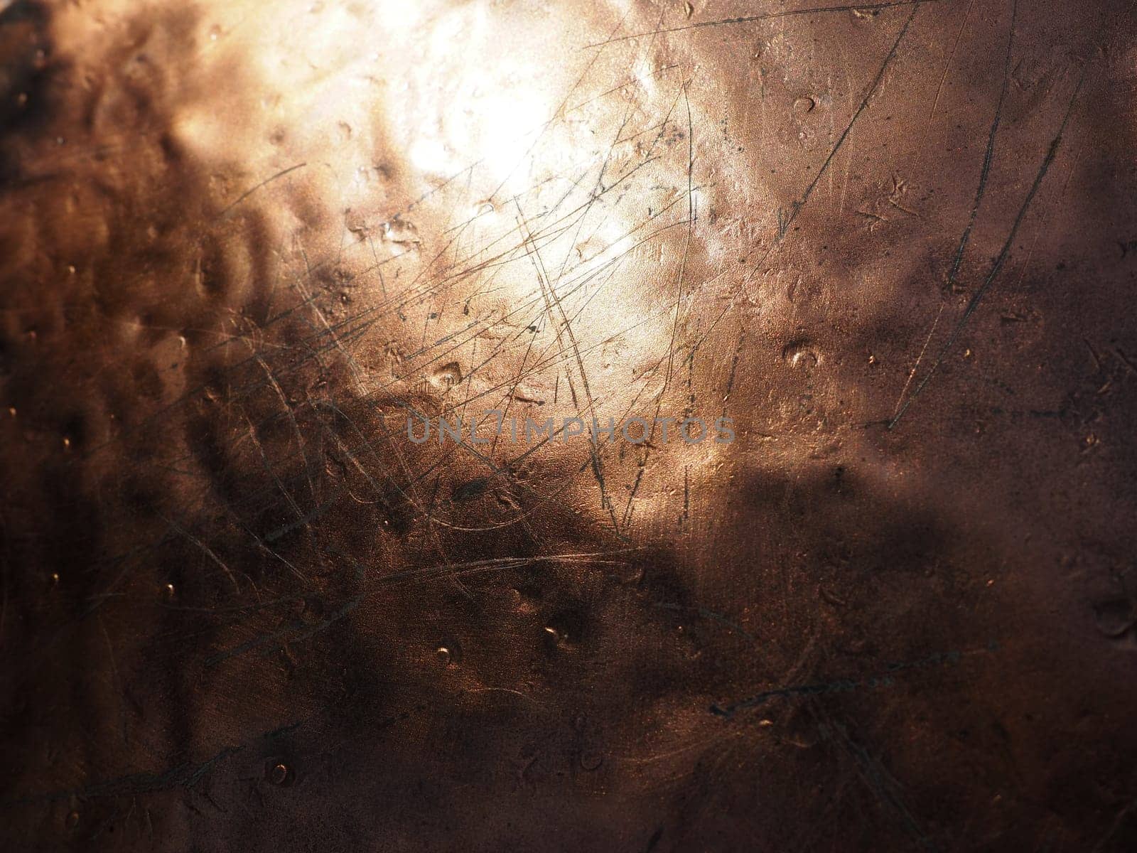 Metal bronze textured plate. Bronze or copper polished surface with dents, scratches and indentations. Metal texture.