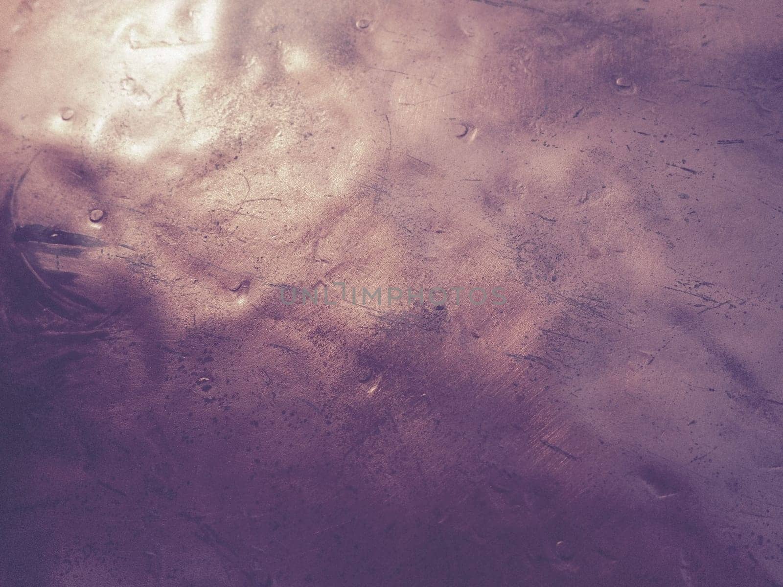 Metal bronze textured plate. Bronze or copper polished surface with dents, scratches and indentations. Metal texture.