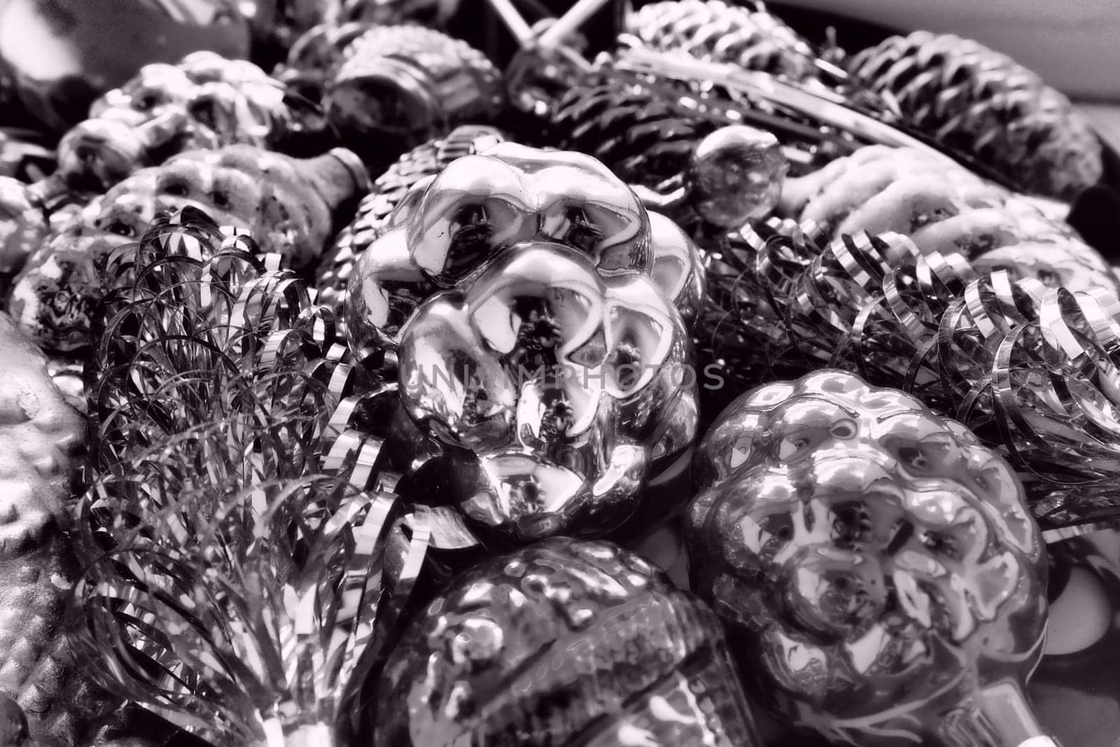 New Year and Christmas tree decorations, glass balls in the form of cones and baskets. Cones and pendants shiny tinsel. Festive background. Lots of Christmas decorations. Black and white monochrome.