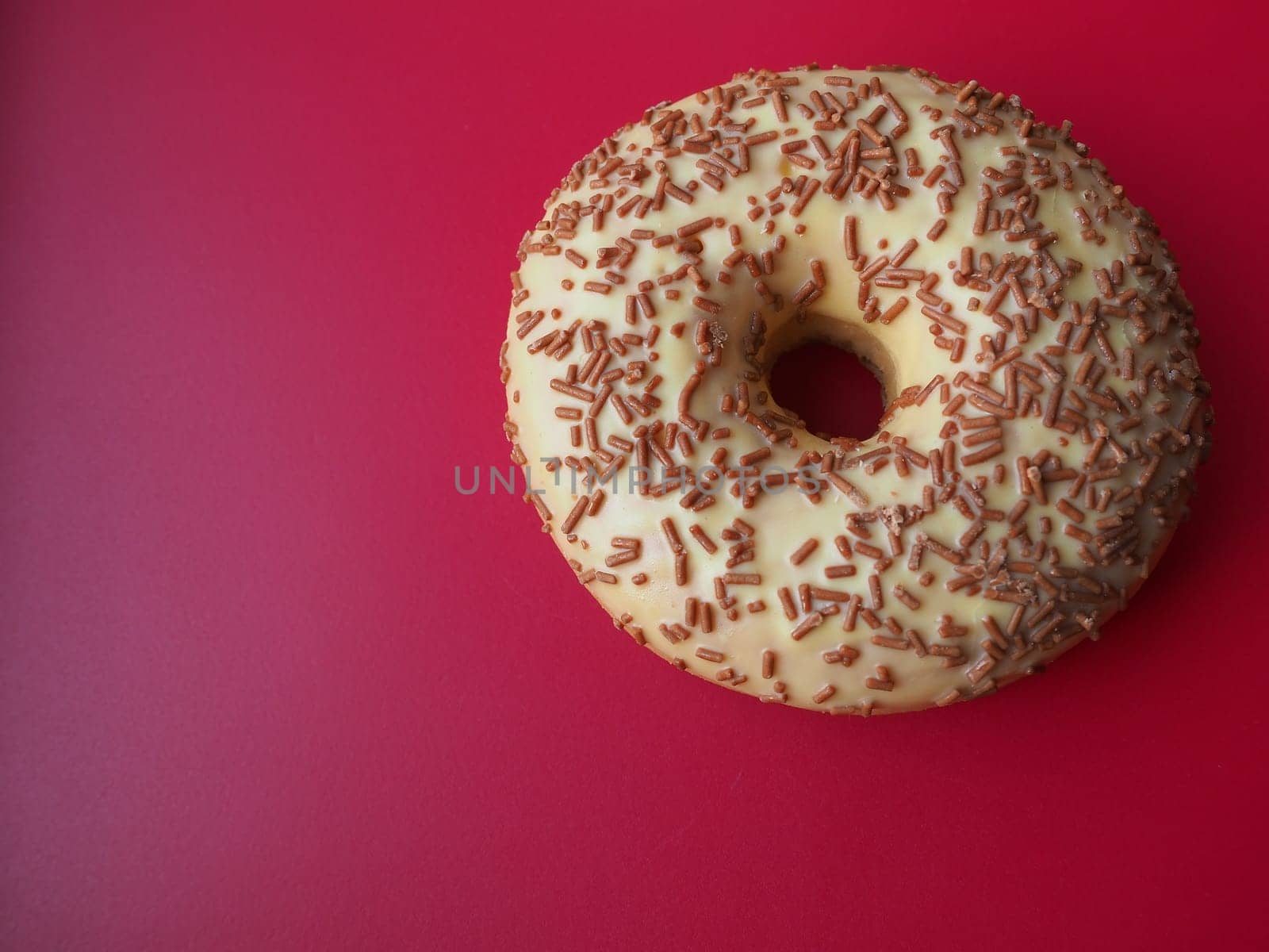 A doughnut or donut. A type of leavened fried dough. Sweet snack. Delicious pie with light icing on gray background.
