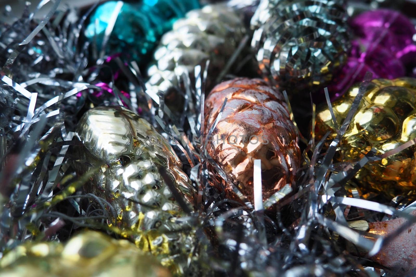 New Year and Christmas decorations, tinsel, boa, Christmas decorations. Multi-colored balls in the form of cones and baskets. Festive interior decoration. New Year or Christmas composition.