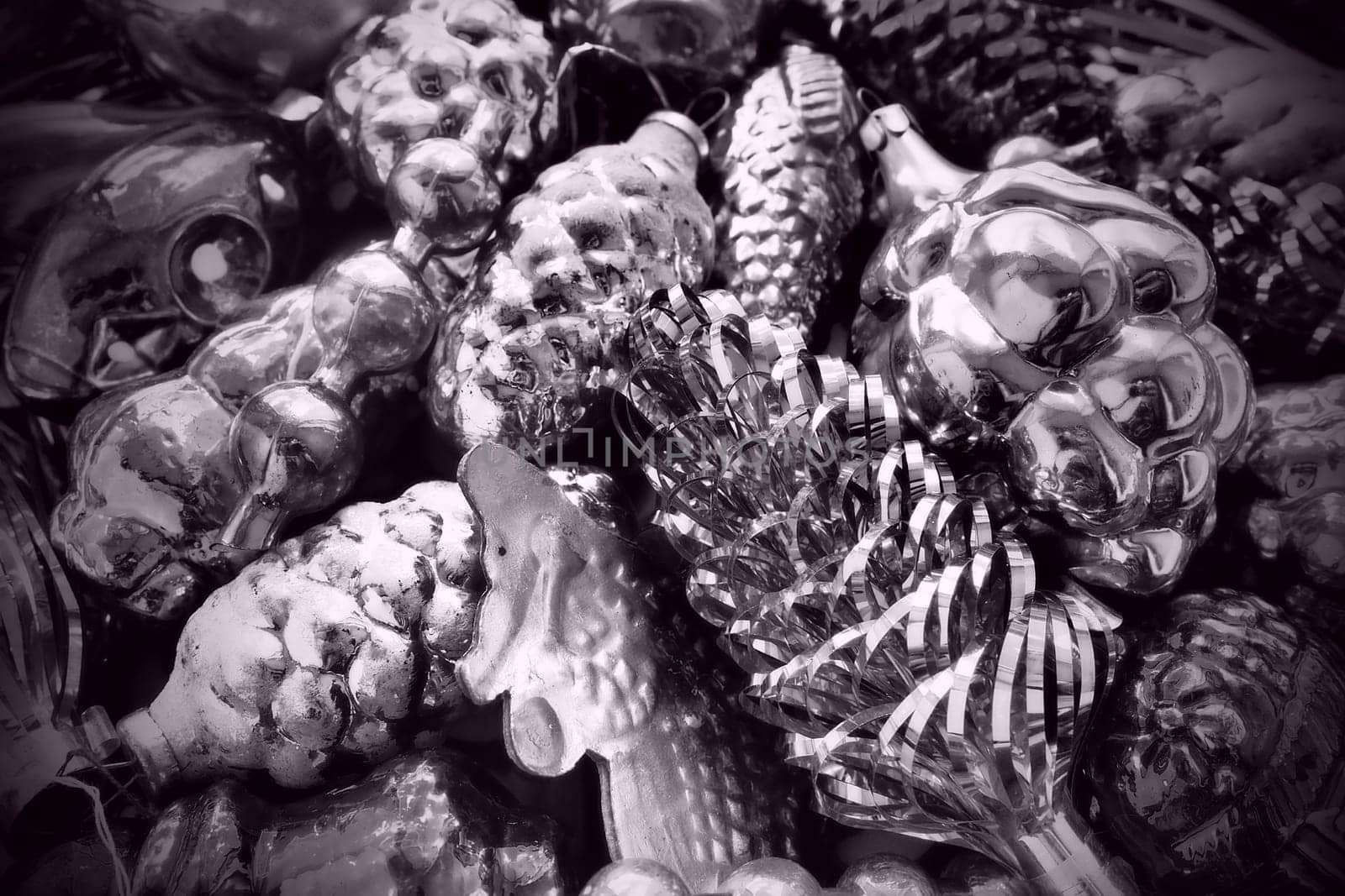 New Year and Christmas tree decorations, glass balls in the form of cones and baskets. Cones and pendants shiny tinsel. Festive background. Lots of Christmas decorations. Black and white monochrome.