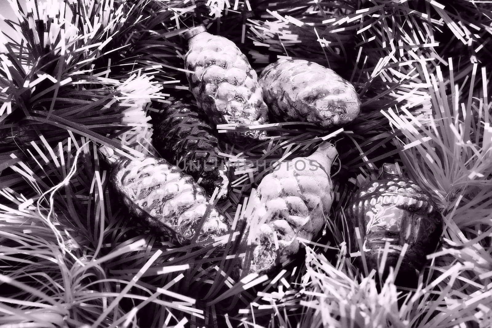 New Year and Christmas tree decorations, glass balls in the form of cones and baskets. Cones and pendants shiny tinsel. Festive background. Lots of Christmas decorations. Black and white monochrome.