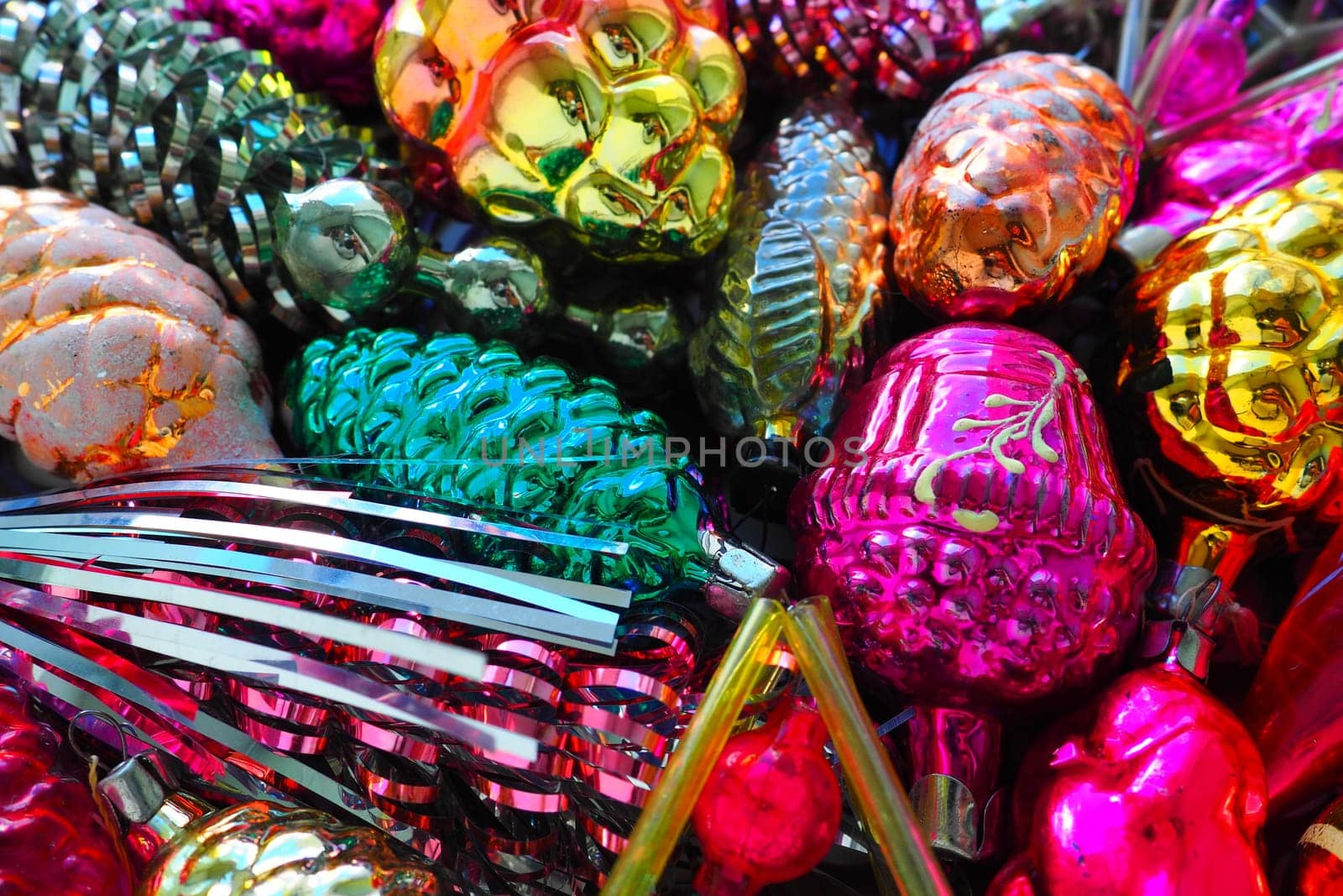 New Year and Christmas tree decorations, glass balls in the form of cones and baskets. Cones and pendants made of shiny tinsel. Festive background postcard layout blank. Lots of Christmas decorations