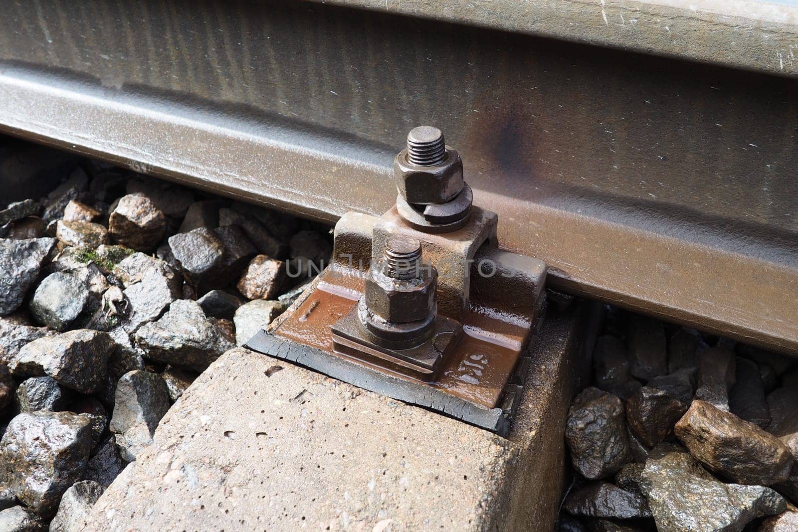 Railways. Metal steel rails and wooden sleepers. Rivets and fasteners on the railroad. Stony backfill of railway tracks. Station Nyrki, Karelia