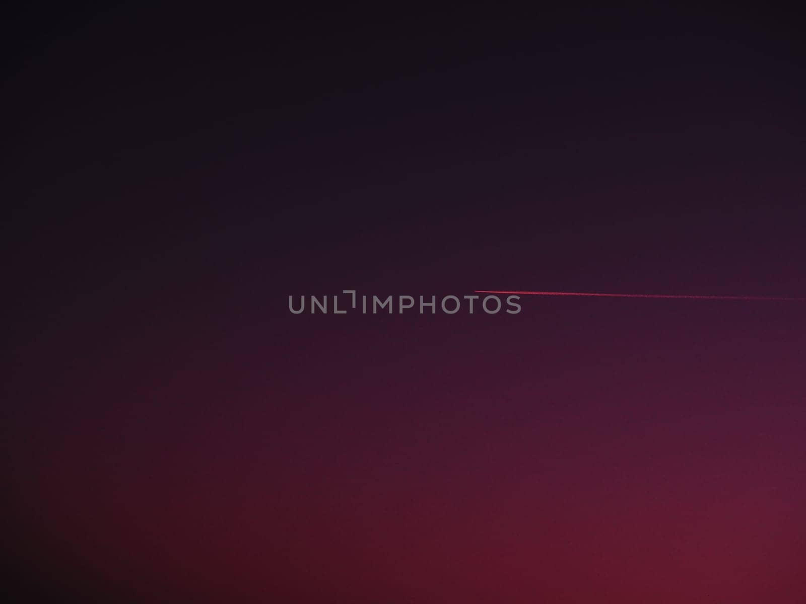 the plane and the trail in the crimson-burgundy sky. Abstract background on space or aero theme.