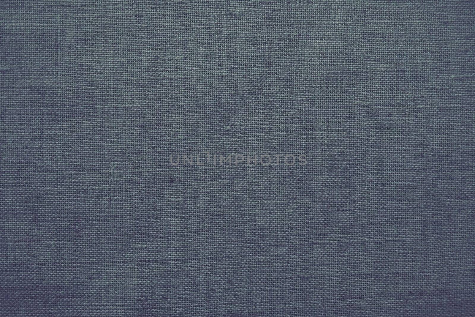 Fabric texture background. Gray fabric with weave. Natural slightly wrinkled look of the material. Uniform copy space background. Cotton, canvas or woolen thin fabric laid evenly on the surface