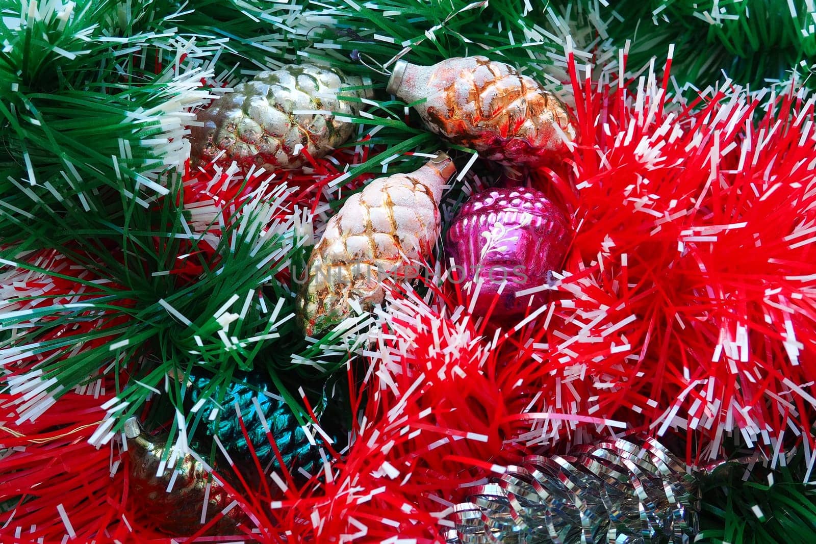 New Year and Christmas decorations, tinsel, boa, Christmas decorations. Multi-colored balls in the form of cones and baskets. Festive interior decoration. New Year or Christmas composition.