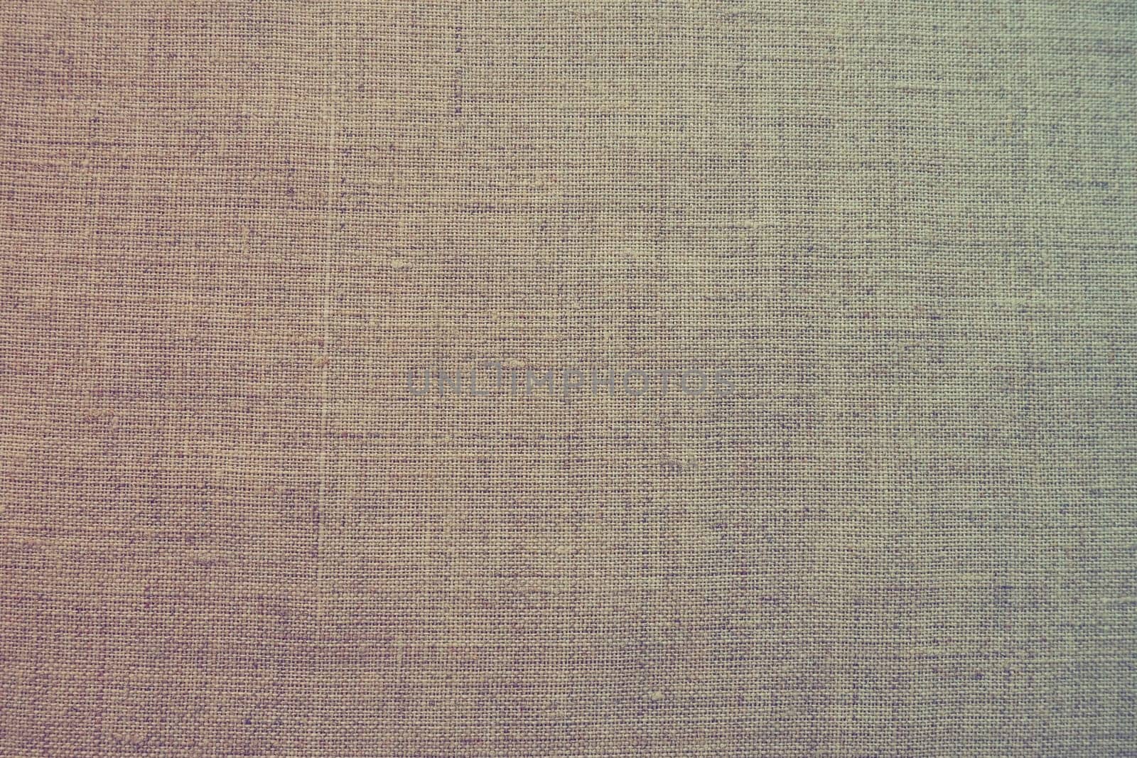 Fabric texture background. Colorful gradient fabric with weave. Natural slightly wrinkled look of the material. Uniform copy space background cotton canvas or woolen fabric laid evenly on the surface