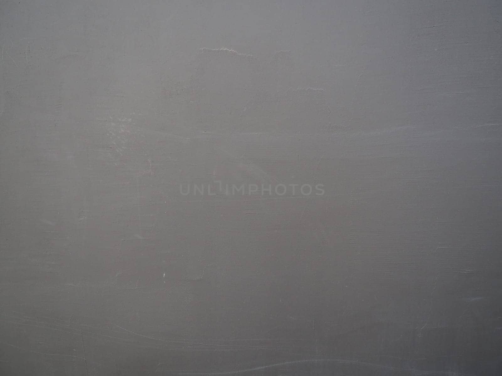 Gray concrete wall with plaster relief. Background texture.