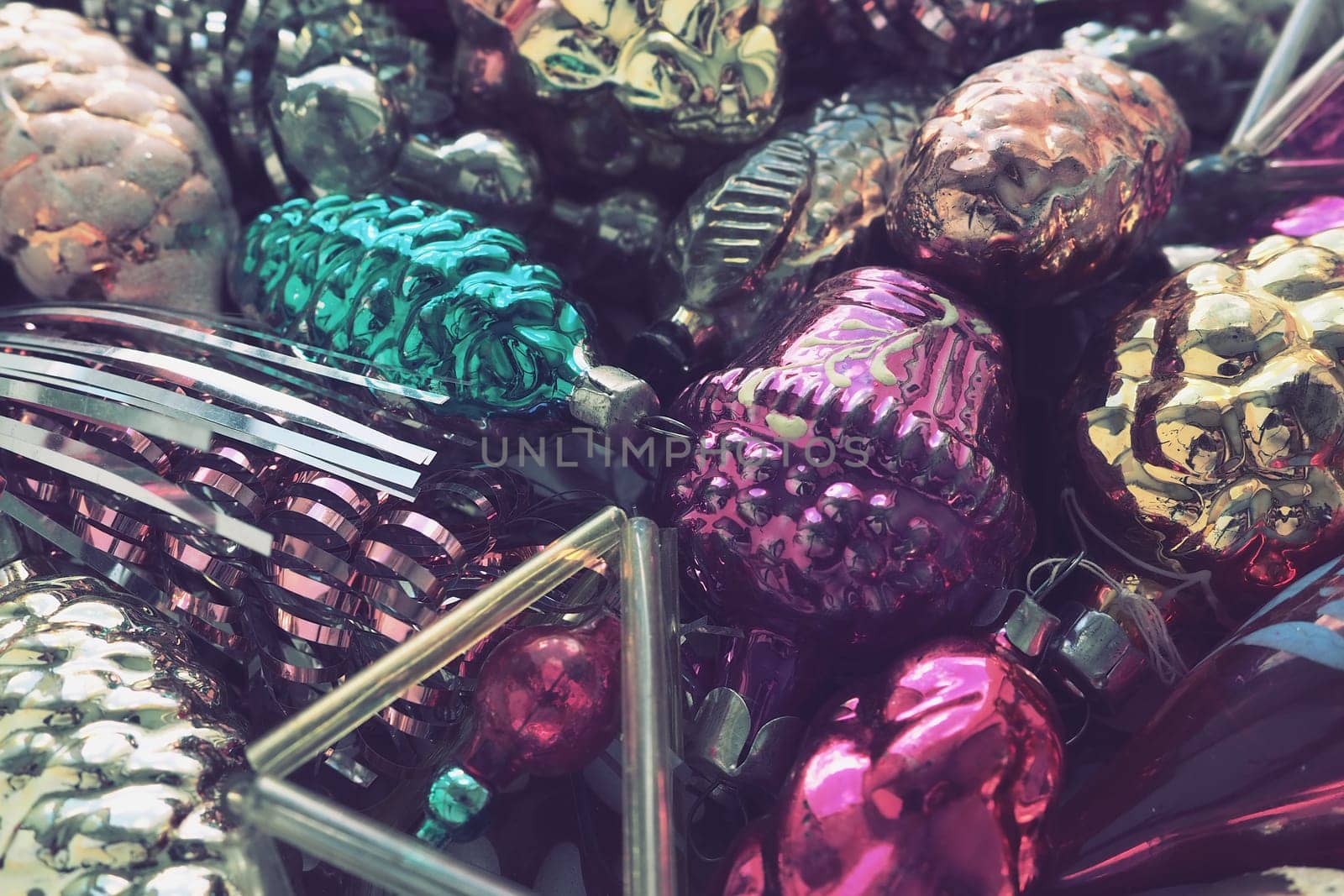 New Year and Christmas tree decorations, glass balls in the form of cones and baskets. Cones and pendants made of shiny tinsel. Festive background. Lots of Christmas decorations. Retro vintage style