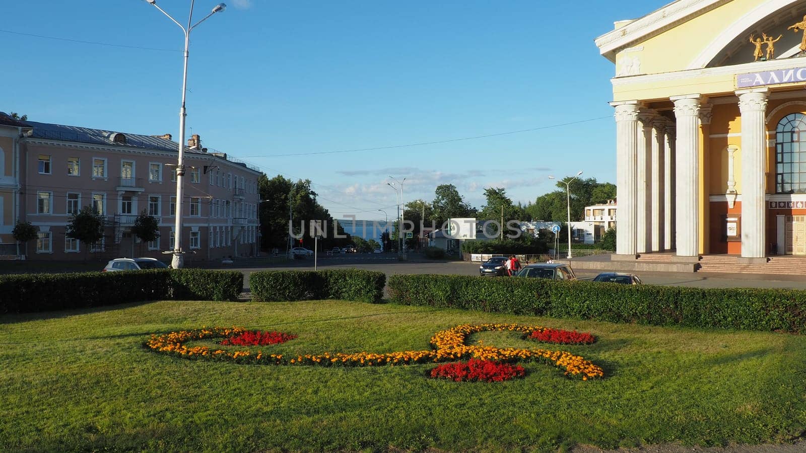 Musical Theater of the Republic of Karelia, Petrozavodsk. Passers-by are walking sunny evening on August 3, 2022 Park of Culture and Leisure. View of Lake Onega. Lawn with marigold flowers. Road signs