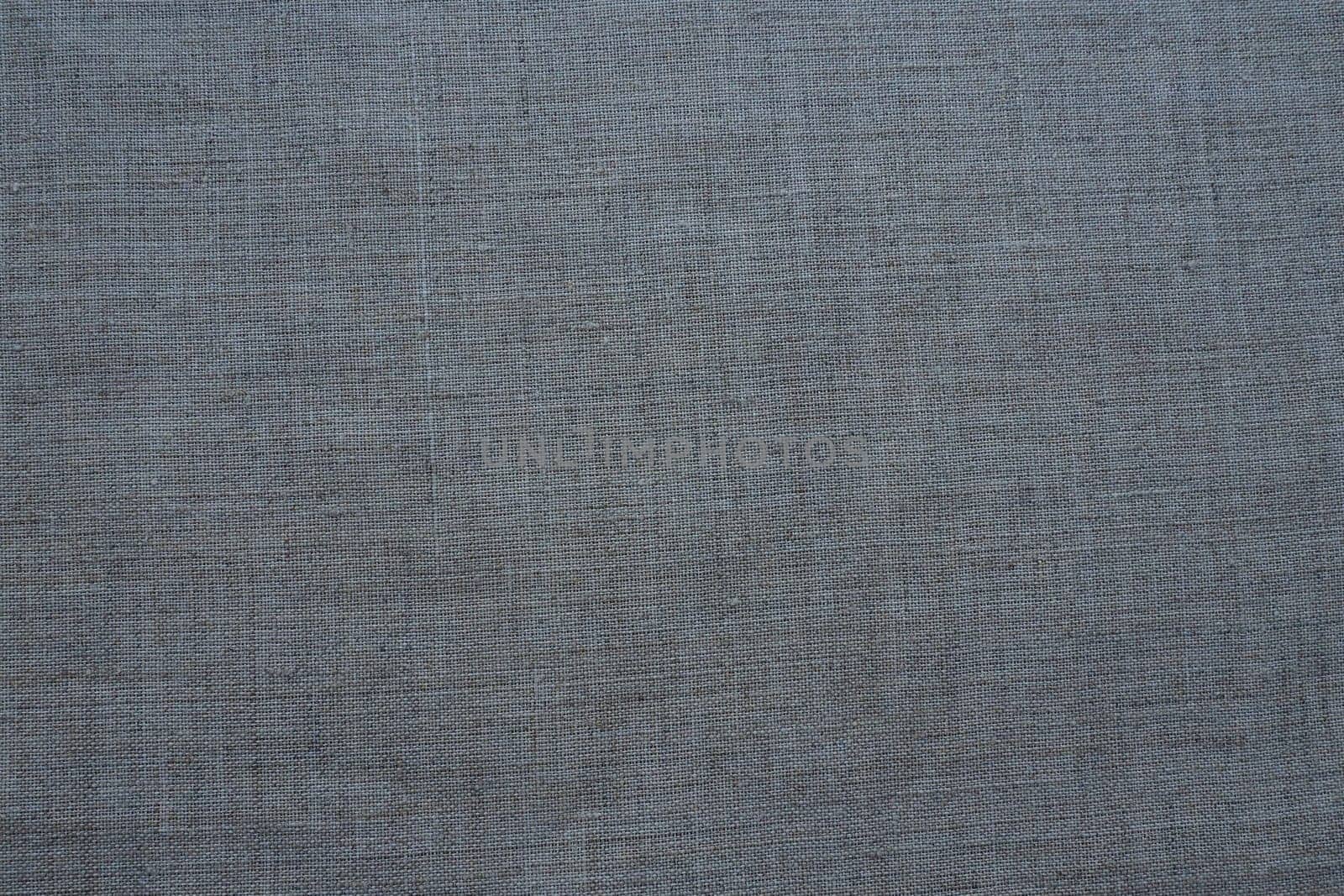 Fabric texture background. Gray fabric with weave. Natural slightly wrinkled look of the material. Uniform copy space background. Cotton, canvas or woolen thin fabric laid evenly on the surface