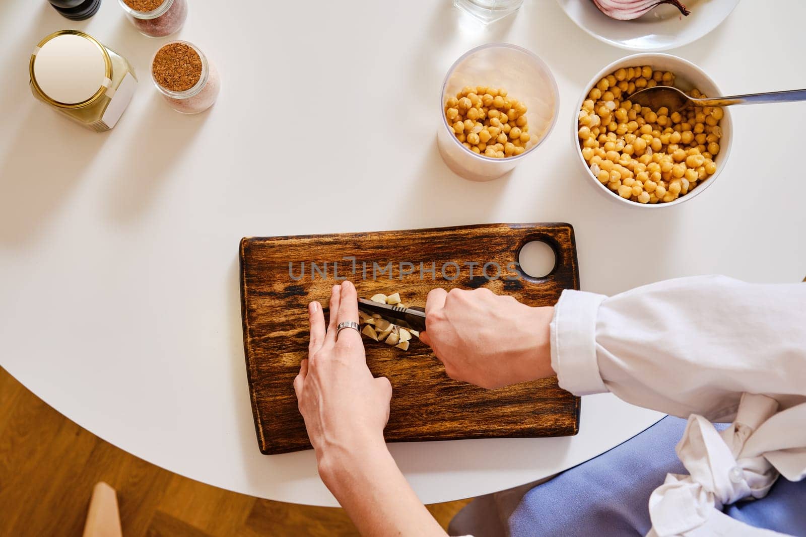 Top view of chopping garlic for hummus