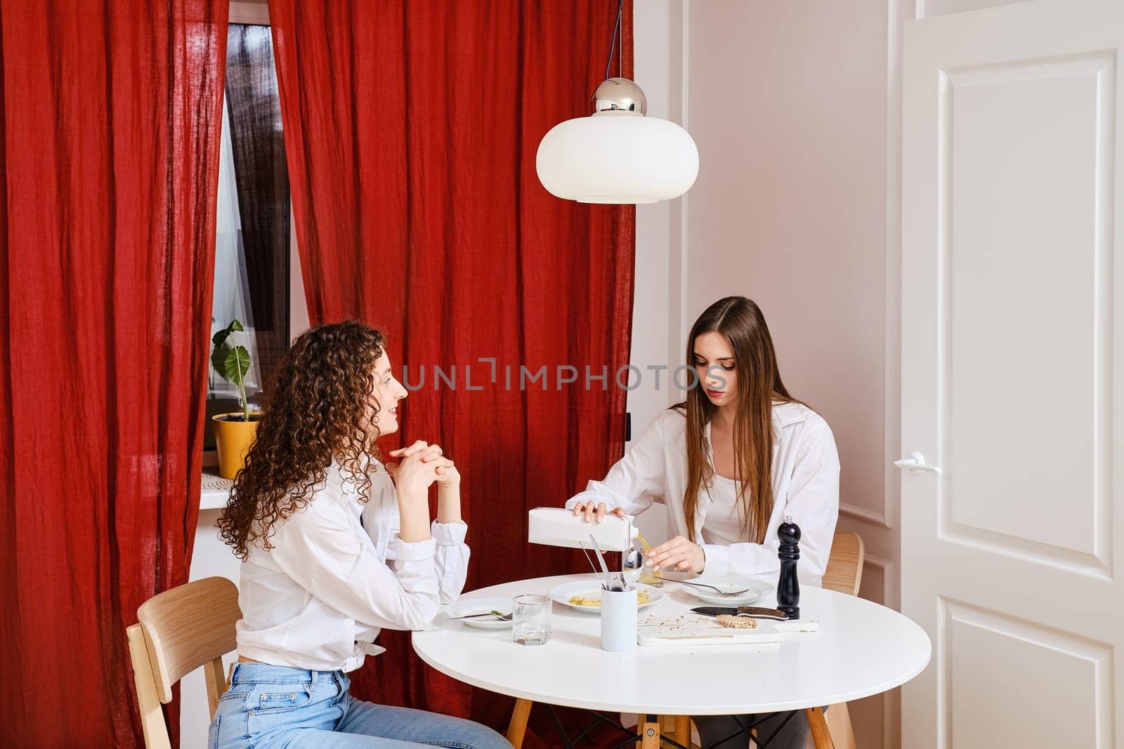 Woman sharing with her friend about tricks of healthy food that is easy to cook at home
