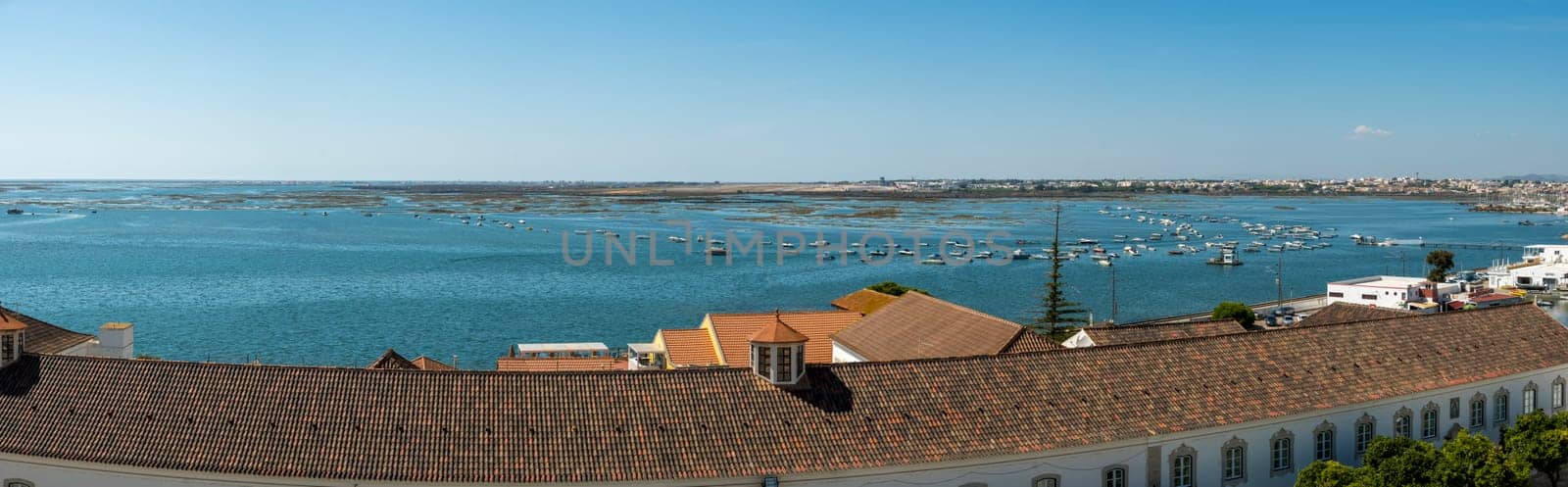 Faro, Portugal, September 2022: Panorama high angle view on the coastline of the city of Faro in Portugal.