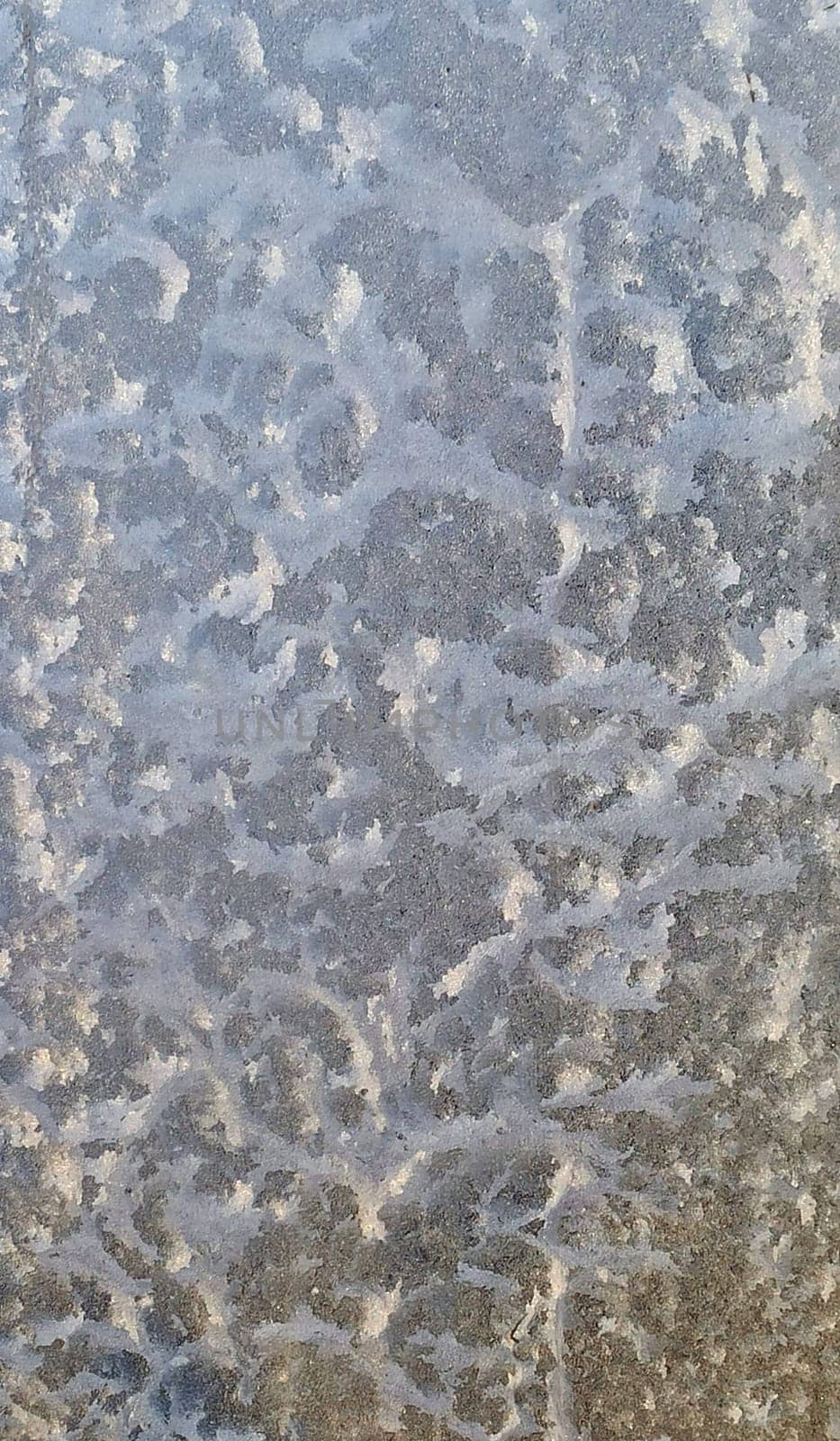 blue ice frozen water natural background. process of Deposition on glass. Winter pattern. Texture winter background. Patterned texture from frozen water on the glass. desublimation. natural design