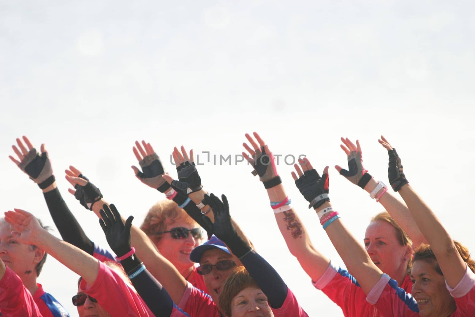 Dragon boat racers wave their hands to show unity.