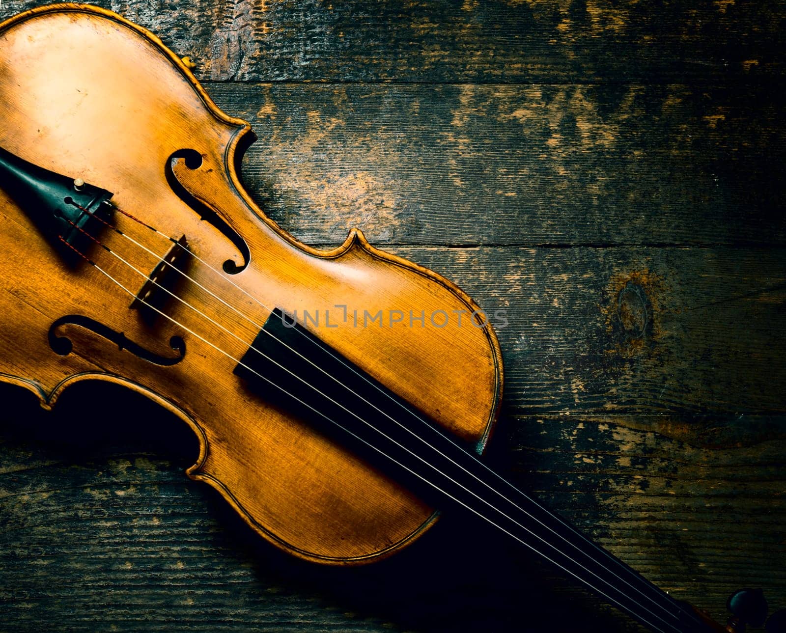 Violin on rustic wooden background from above. Classical musical string instrument. Classic music concept.
