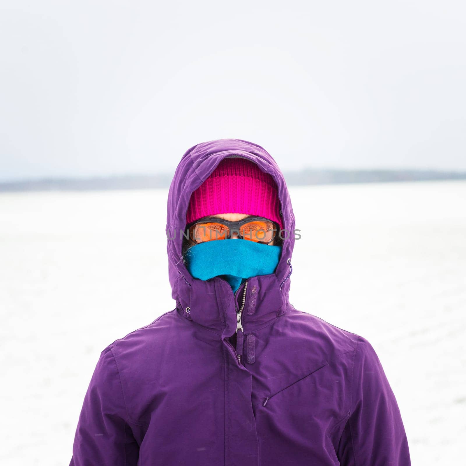 Woman walking in snow in winter clothes
