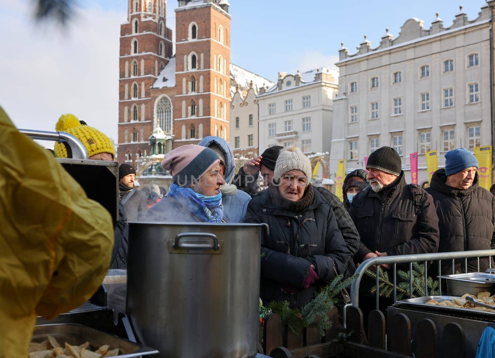 Krakow, Poland - Dec 18, 2022: Christmas Eve for poor and homeless on the Main Square in Cracow. The group Kosciuszko prepares the greatest eve in the open air in Krakow