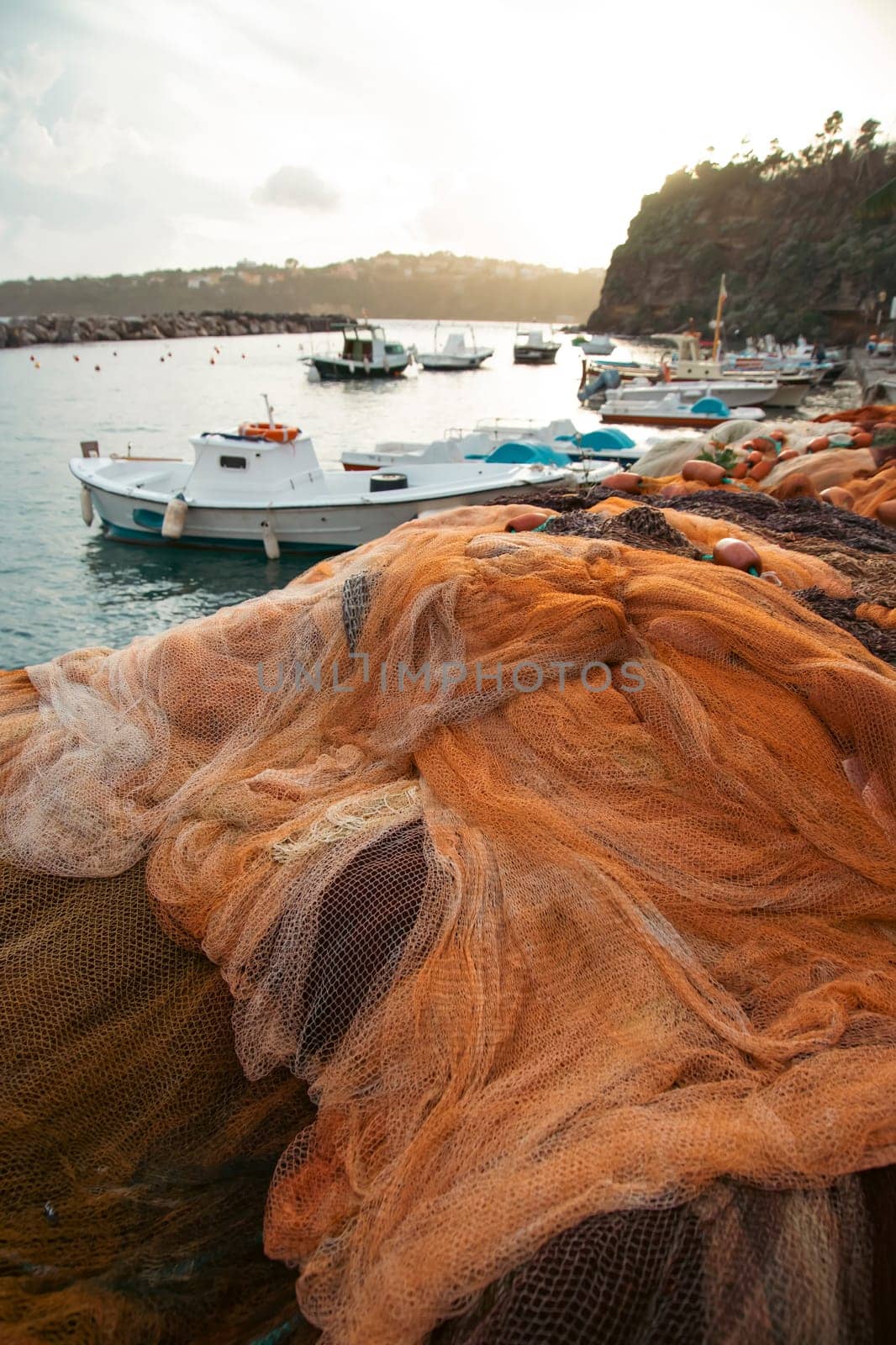 View of the Port of Corricella with lots of colorful houses on a sunny day in Procida Island, Italy.