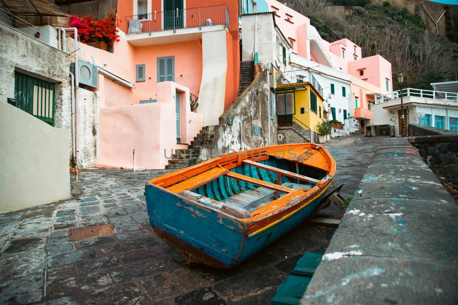 View of the Port of Corricella with lots of colorful houses on a sunny day in Procida Island, Italy.