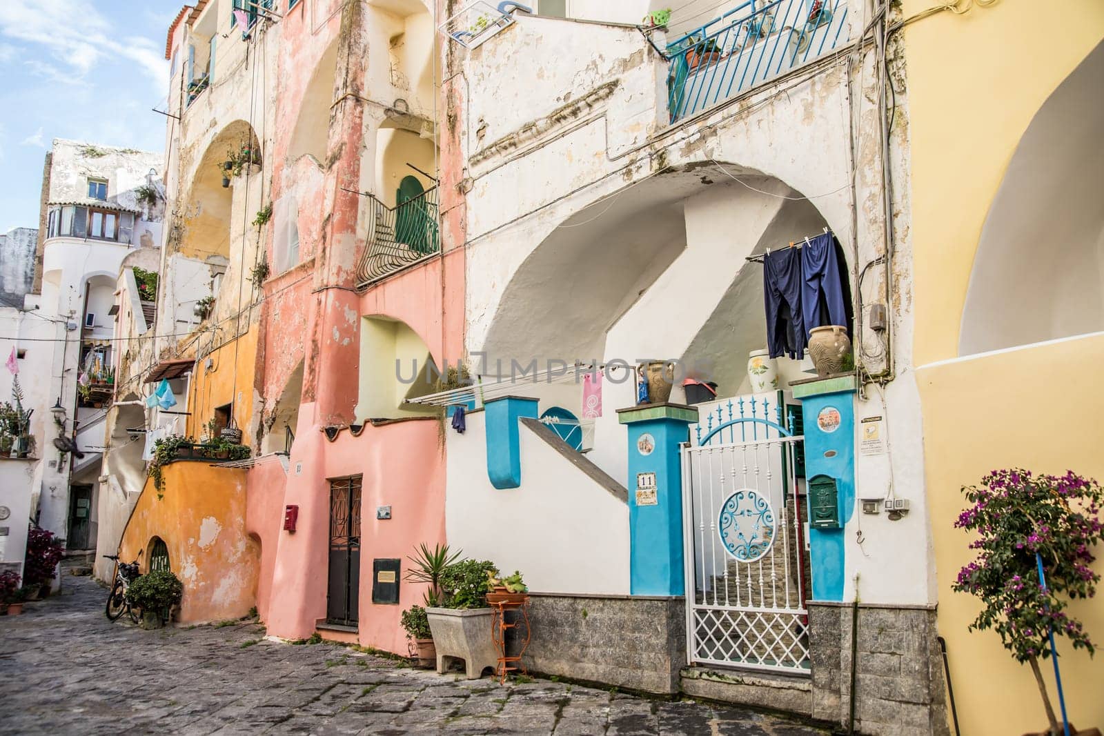 Procida island with colorful houses in small town street