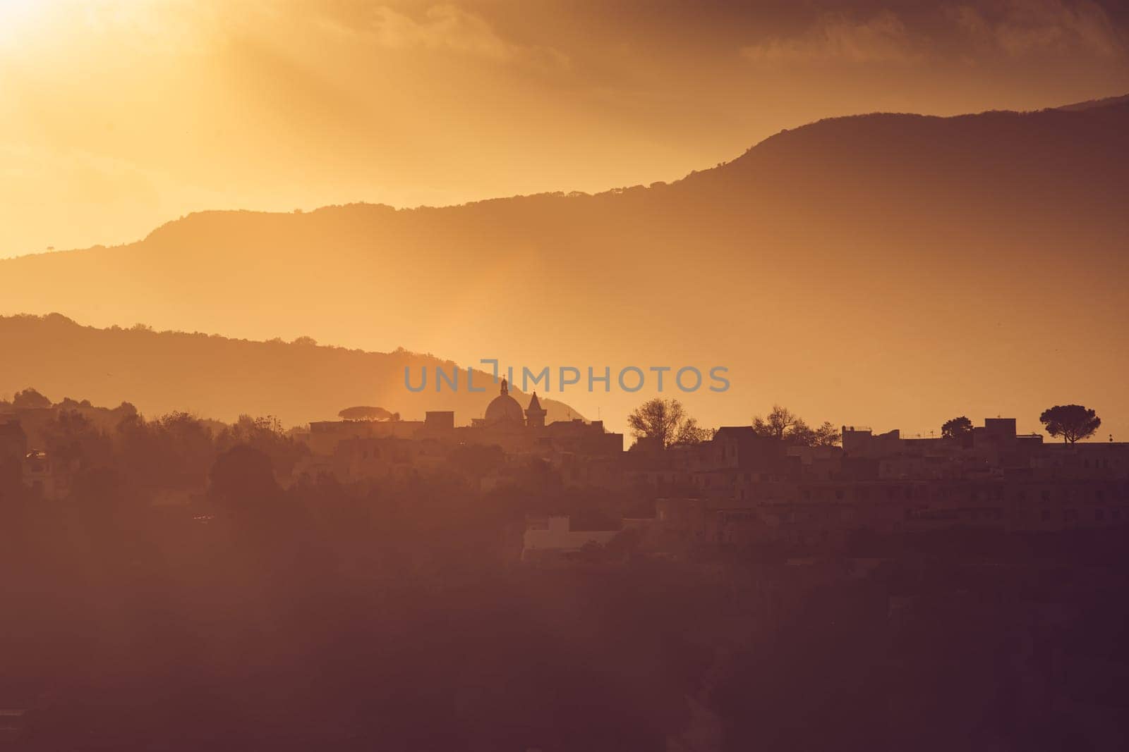 Magic sunset over Procida Island with Ischia island in the background.