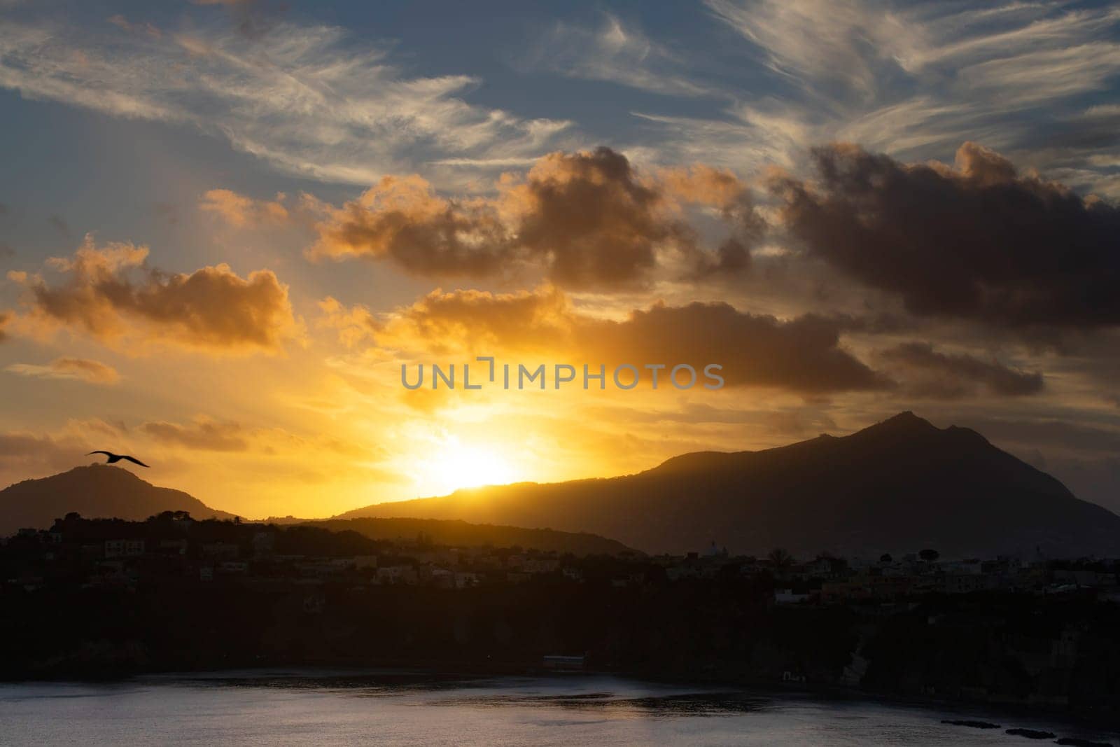 Magic sunset over Procida Island with Ischia island in the background.