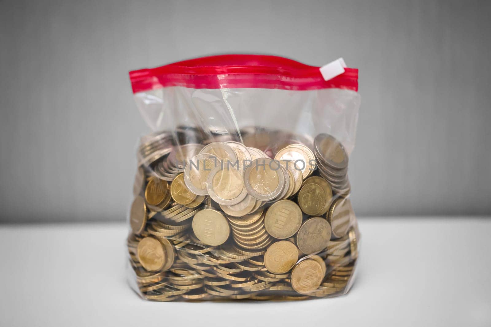 Many coins, euros stored in a plastic bag.