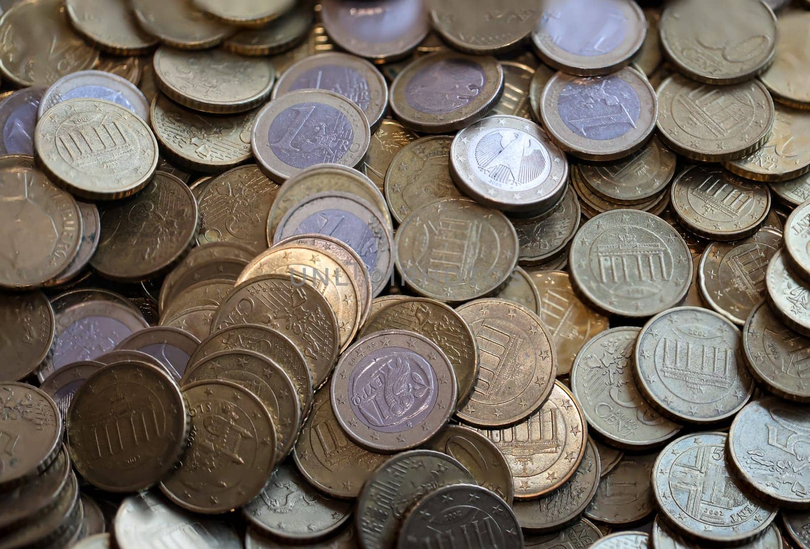 Many coins, euro currency lying in a heap.