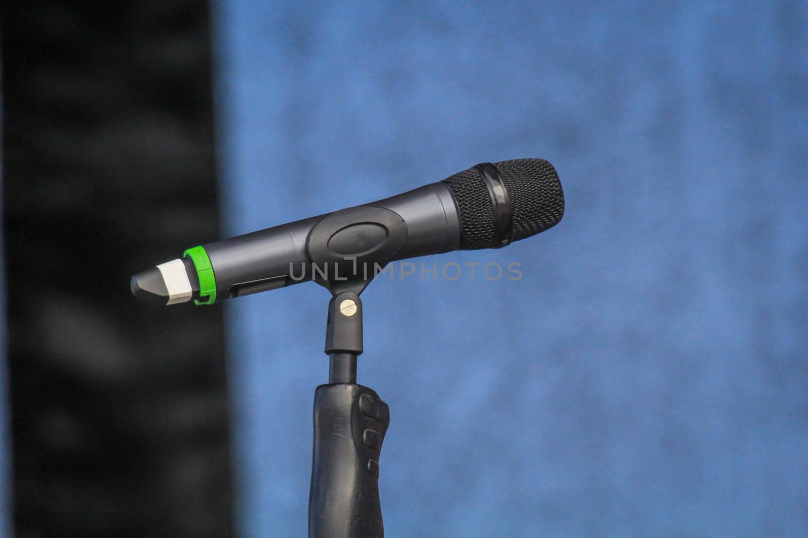 On a stage there is a microphone unused during a break.