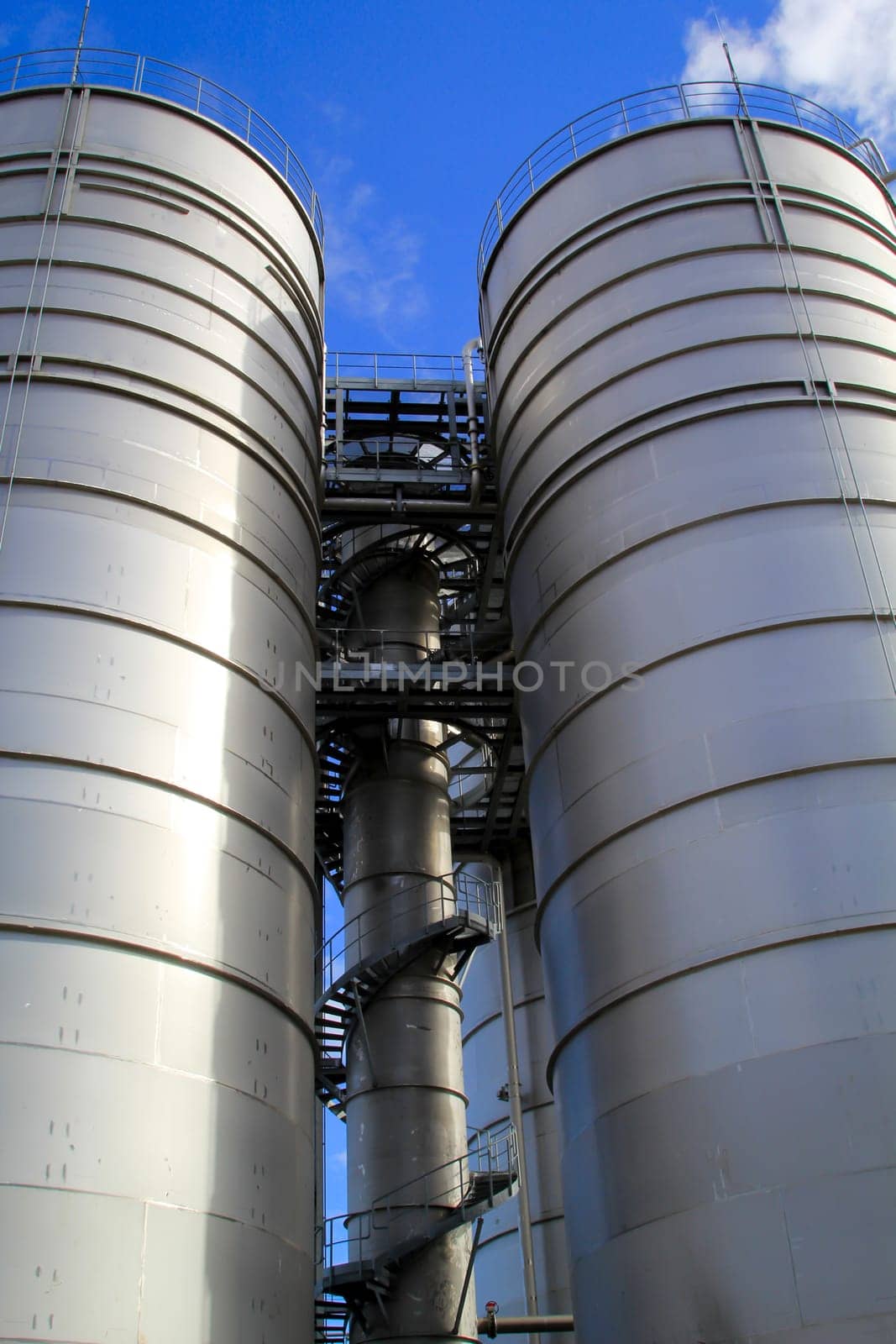 Two huge bunkers, storage or silos for industrial raw materials.