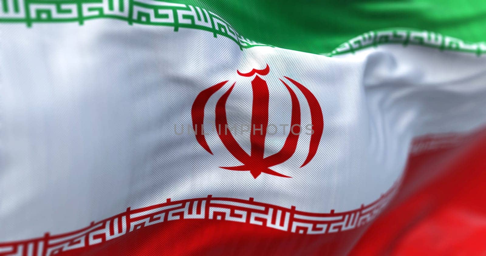 The Iran national flag waving. The Islamic Republic of Iran is a State of Asia located on the Middle East. Rippled fabric. Textured background. Selective focus. Realistic 3d illustration. Close-up
