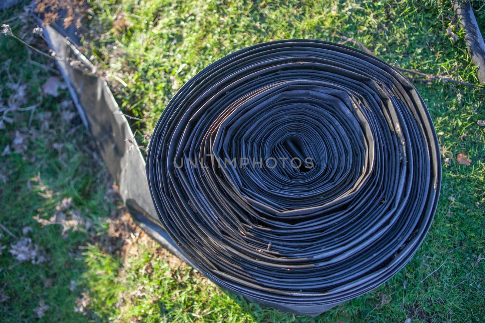 Rolled tape of flexible irrigation tubing system. Overhead view