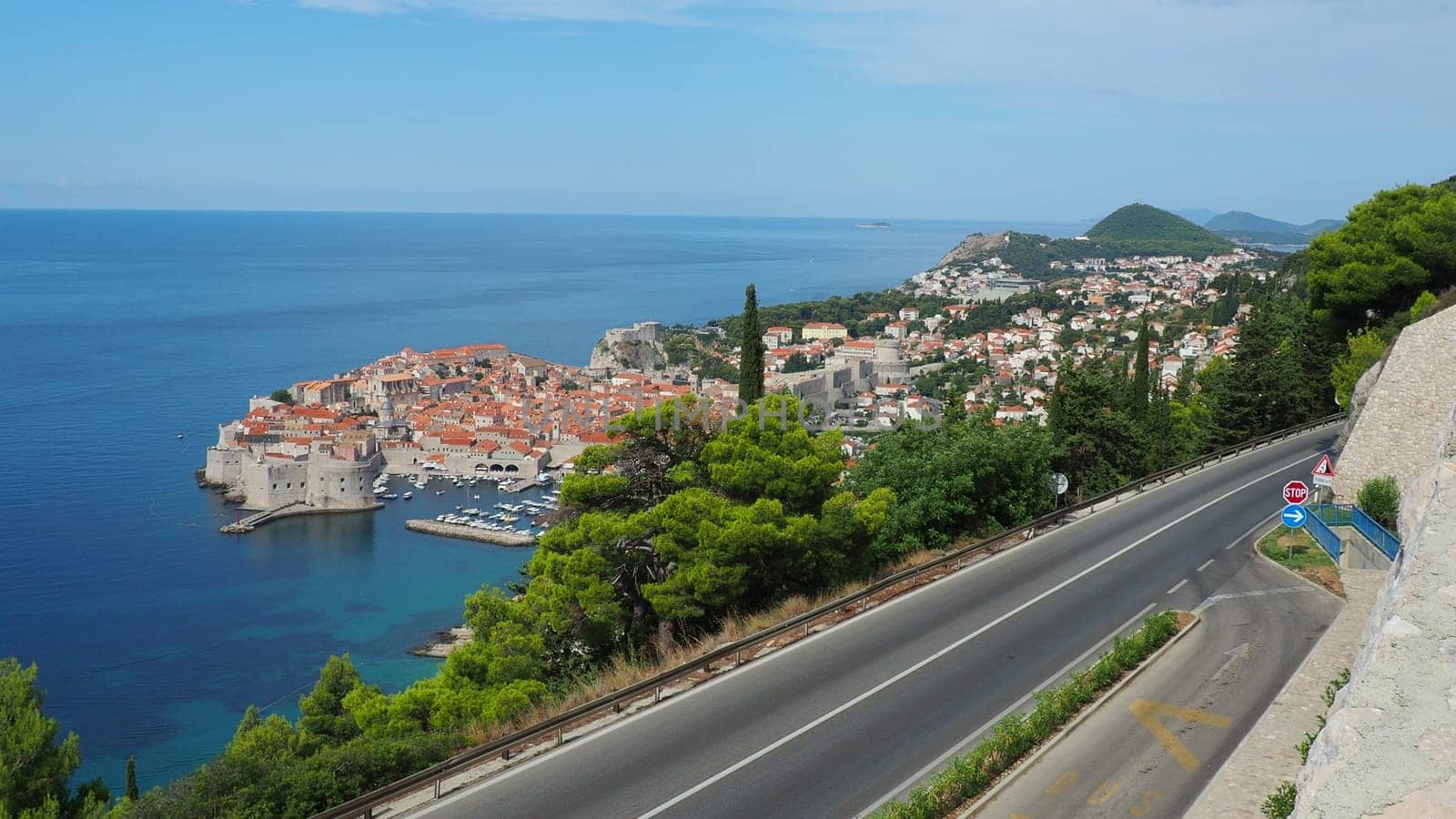 Road traffic near Dubrovnik old town in Croatia. Dubrovnik Ragusa is a city in Croatia, the administrative center of the Dubrovnik-Neretva County. Top view from the observation deck on the rock