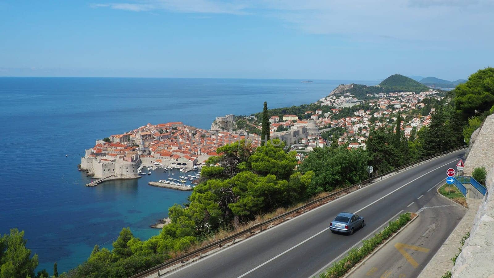 Road traffic near Dubrovnik old town in Croatia. Dubrovnik Ragusa is a city in Croatia, the administrative center of the Dubrovnik-Neretva County. Top view from the observation deck on the rock