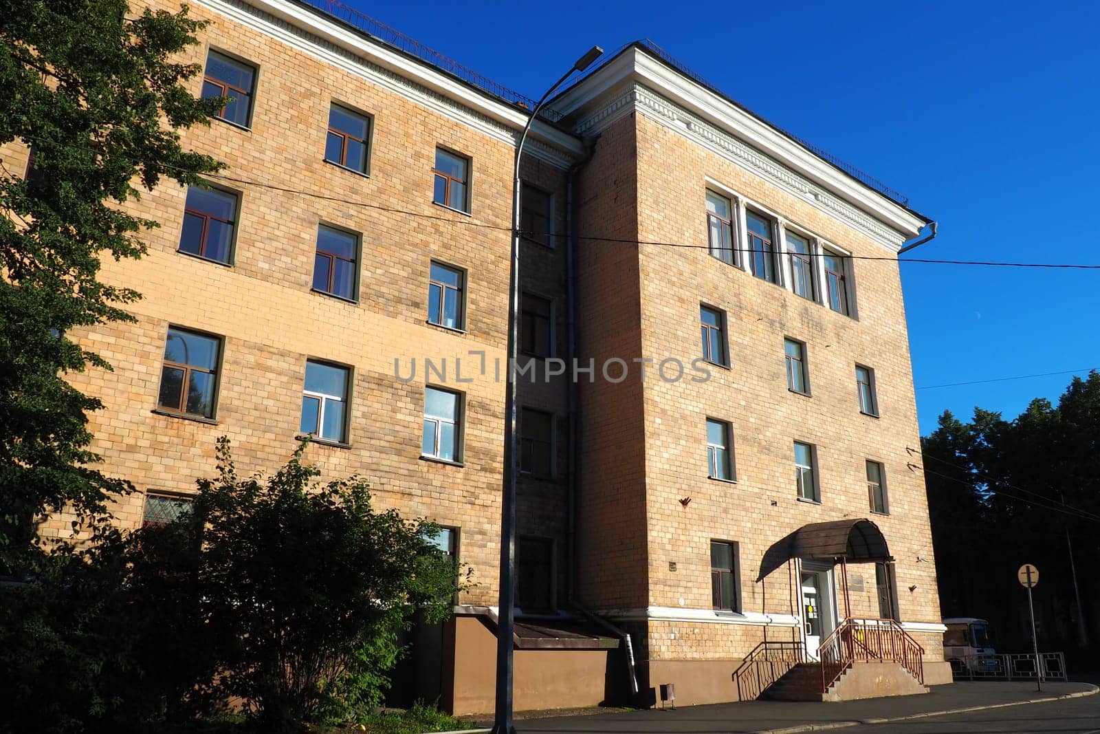 Petrozavodsk, Republic of Karelia, Russia August 3 2022 Facade of the building of the Faculty of Economics of Petrozavodsk State University. Crossing the Gylling embankment and Pravda street. Evening