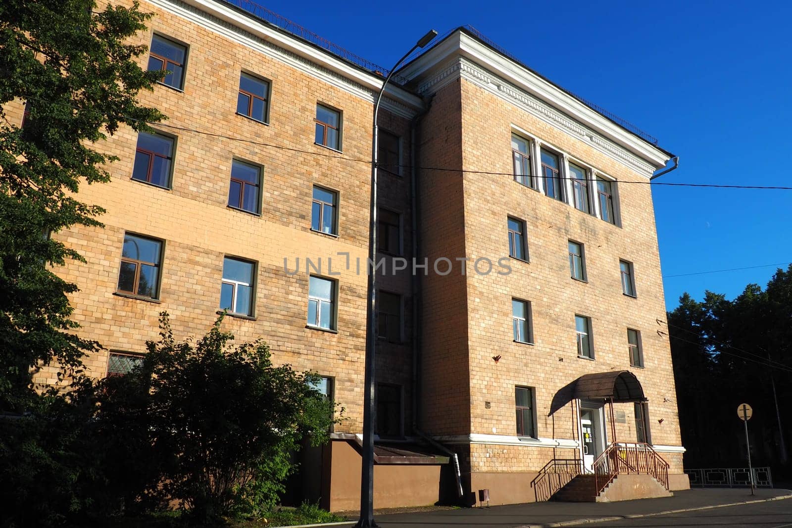 Petrozavodsk, Republic of Karelia, Russia August 3 2022 Facade of the building of the Faculty of Economics of Petrozavodsk State University. Crossing the Gylling embankment and Pravda street. Evening