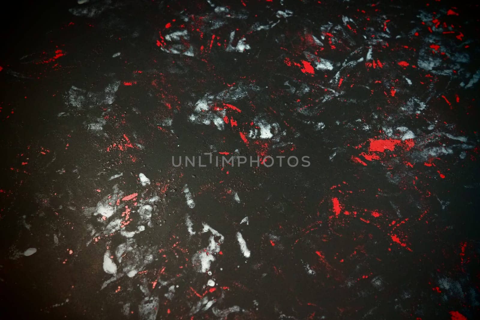Black background with red, white, gray and blue strokes, dashes, stains and scuffs. A ray of light