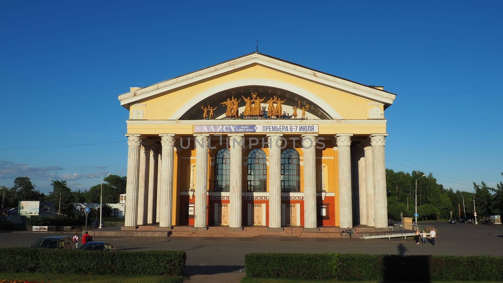 The Musical Theater of the Republic of Karelia, a state theater in Petrozavodsk. People and children are walking. August 3, 2022 Kirov Square. Facade with columns. Cars drive along Pushkinskaya street