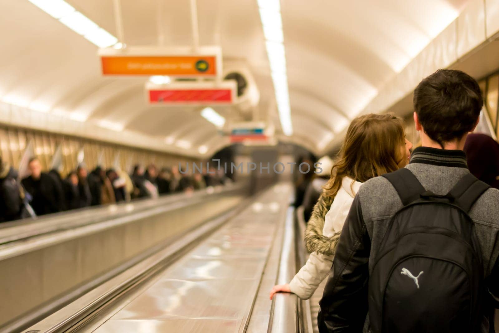 Budapest Hungary: People, commuters, riding the crowded and densely populated escalators of a subway or metro station in Budapest, making their way to the train tracks. Rush hour.