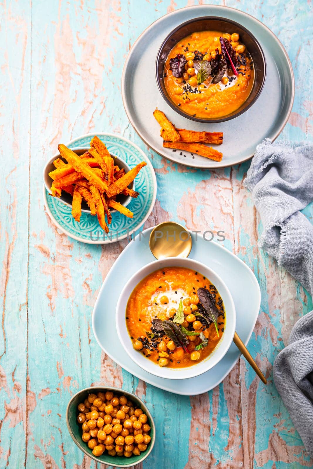 Carrot and sweet potato soup with chickpeas and fresh winter herbs, sweet potato fries