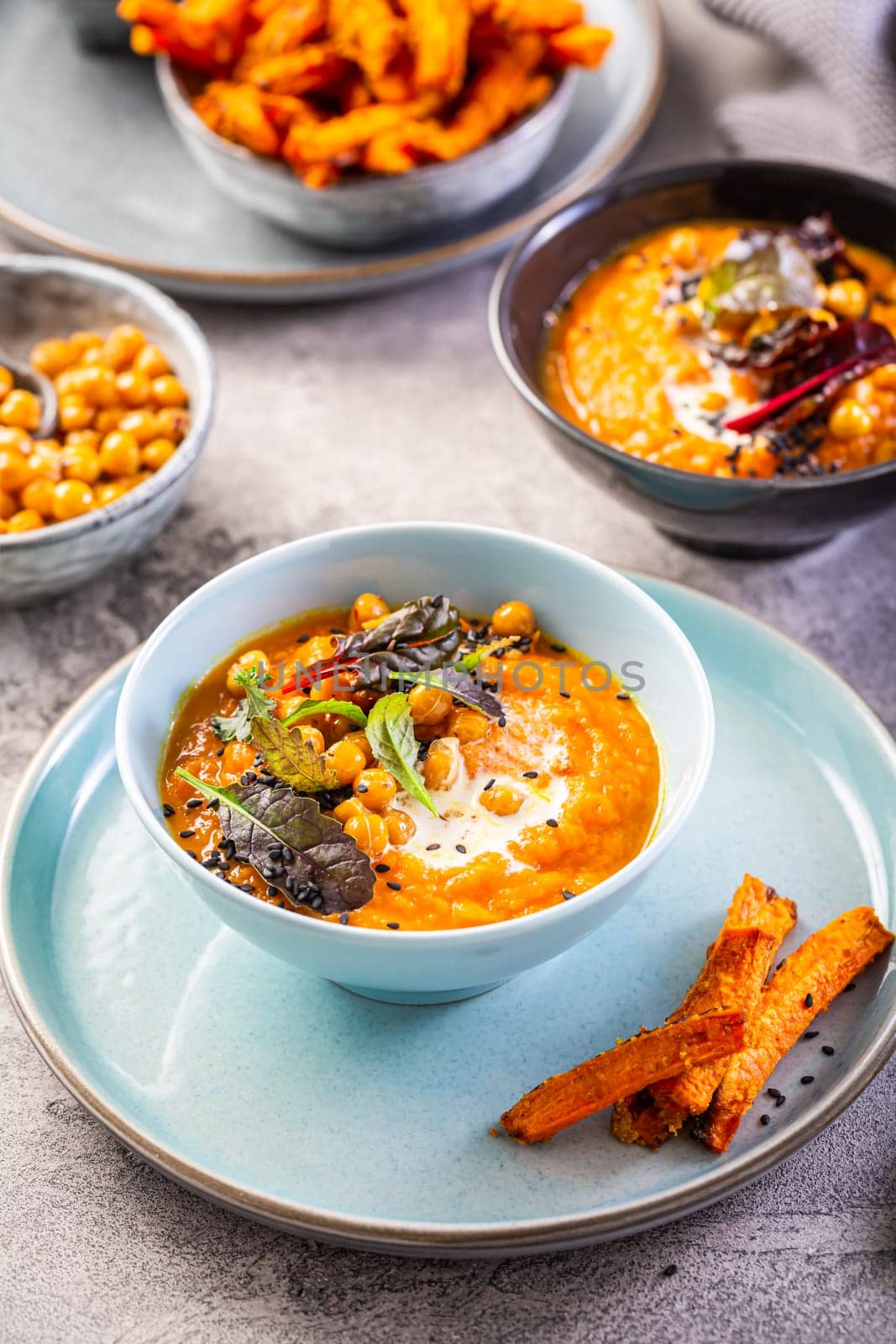 Carrot and sweet potato soup with chickpeas and fresh winter herbs, sweet potato fries