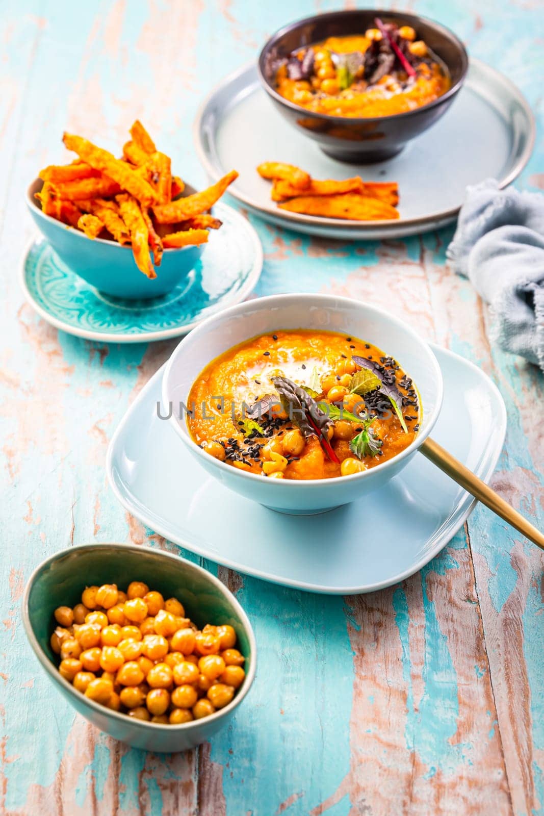 Carrot and sweet potato soup with chickpeas and fresh winter herbs, sweet potato fries