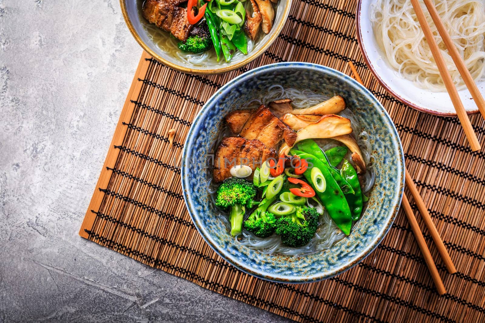 Ramen soup with mushrooms, vegetables, glass noodles and pork