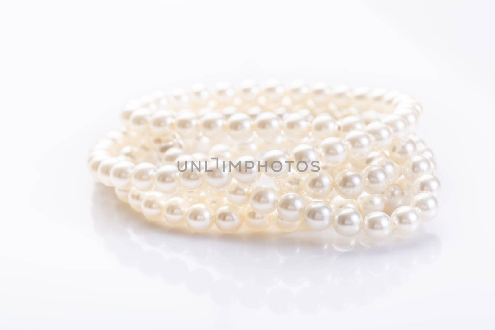 Pearl necklace on white background with copy space