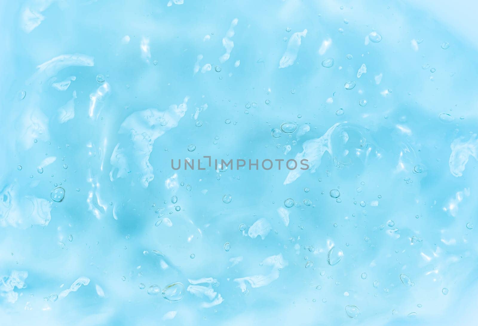 Clear gel serum texture. Liquid skincare cream background. Cosmetic gel product with bubbles close up